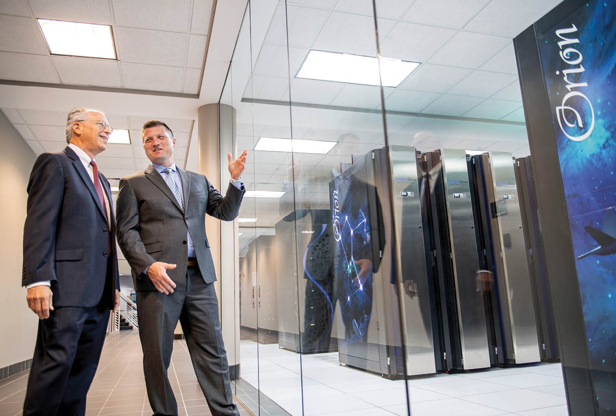 Michael Navicky (Director, HPCC) and Robert Moorhead (Director, Geosystems Research Institute), photographed with the supercomputers housed at the HPCC. (photo by Megan Bean / © Mississippi State University)