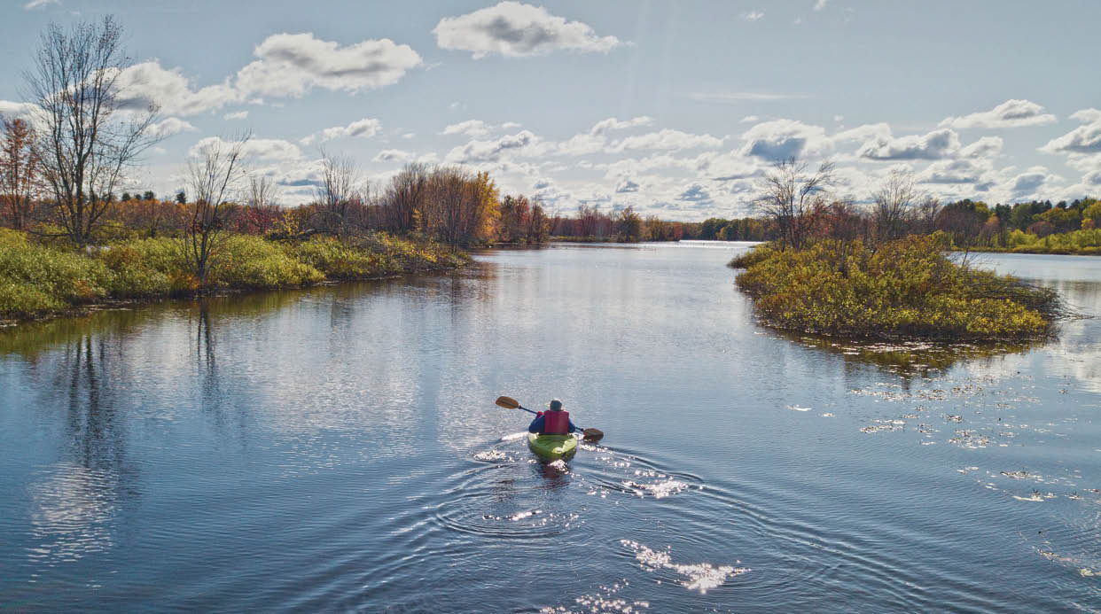 Sheila Cerwonka, paddles upstream on the Raquette River, October 15, from Ives Park in Potsdam , to view the remaining foliage and bird watch. Christopher Lenney/Watertown Daily Times