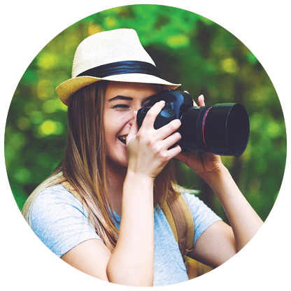 Female photographer in the forest with a camera