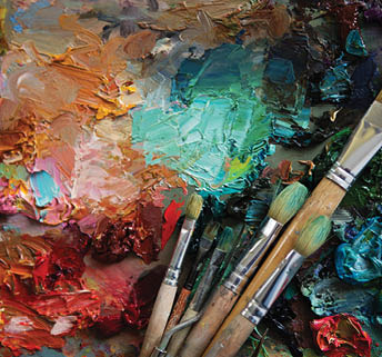 artists brushes and oil paints on wooden palette. Vintage stylized photo of paintbrushes closeup and artist palette. palette with paintbrush and palette-knife