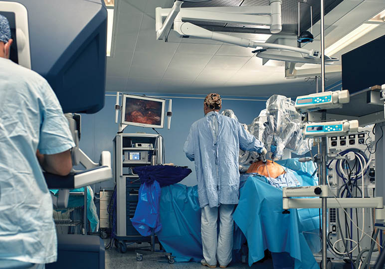 Carrying out an operation using a robot, a robot surgeon with manipulators, a modern operating room, surgeons people perform an operation using a surgeon's robot through the control panel