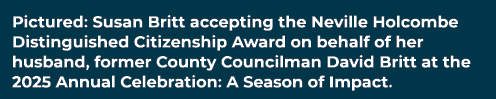 Pictured: Susan Britt accepting the Neville Holcombe Distinguished Citizenship Award on behalf of her husband, former...