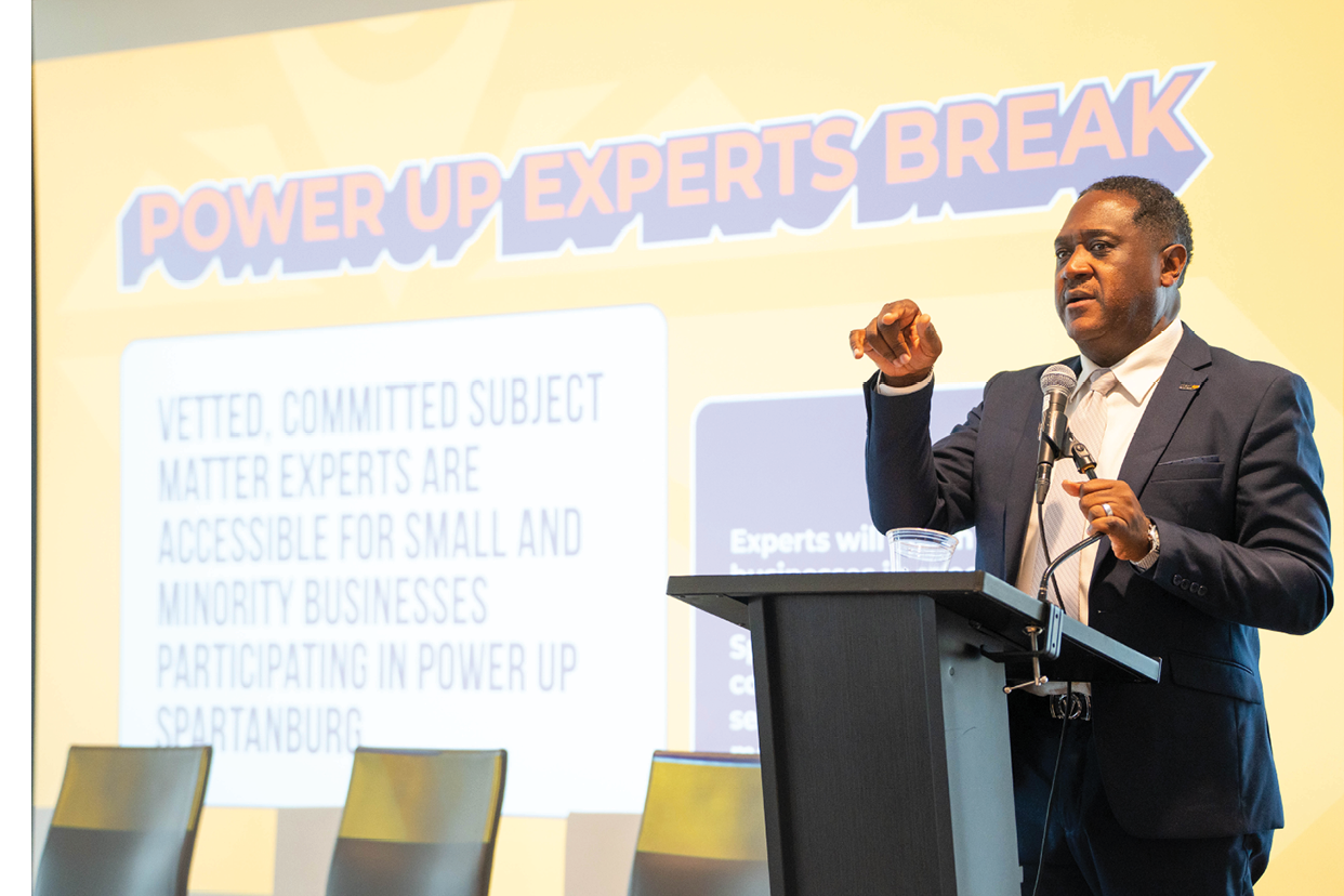 A man in a suit is giving a presentation in front of a projected screen. AI generated content
