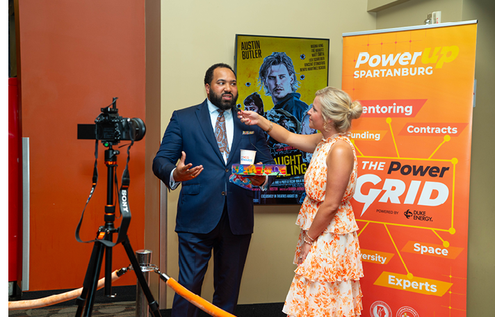 Two people are standing next to a podium with a microphone. One of them is a man wearing a suit and tie. AI generated content