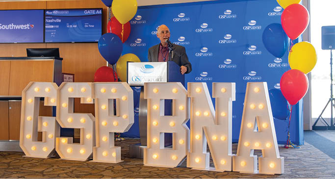 A man is standing in front of a sign that says GSPNA. AI generated content