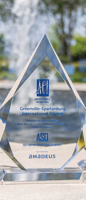 Three crystal awards are displayed on a stone ledge. AI generated content