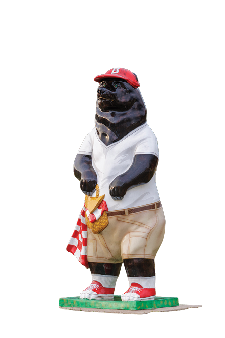 A statue of a bear wearing a baseball cap and a white shirt. AI generated content
