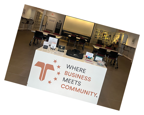 A white desk with a sign that says “Where business meets community". AI generated content