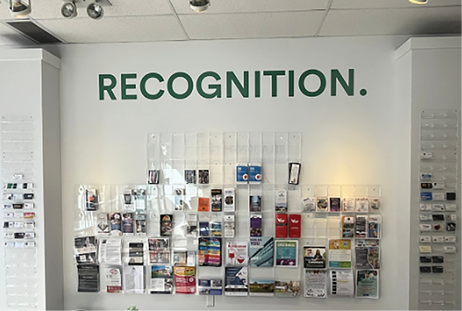 A wall in a room with a sign that says “recognition.". AI generated content