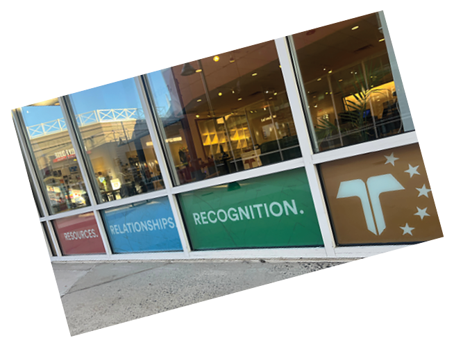 A window on a building with a green, white, and red sign that says “Relationships Recognition." AI generated content