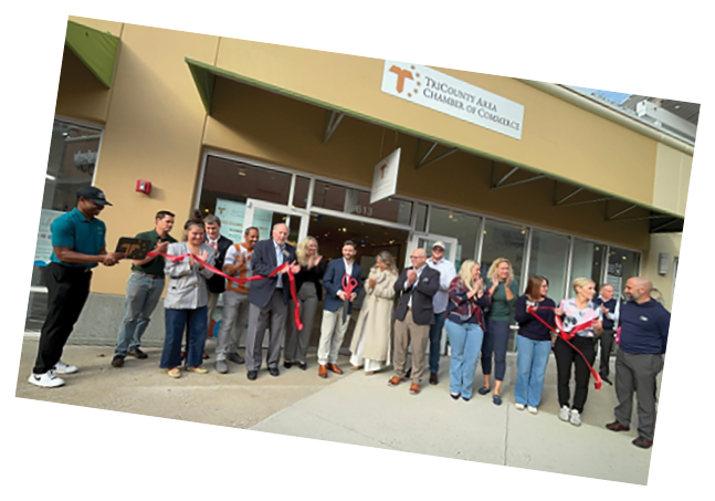 A group of people are standing in front of a building, holding red ribbons. AI generated content