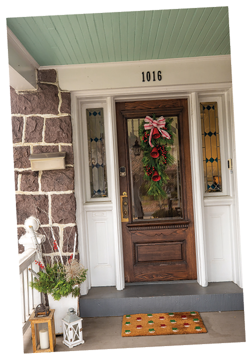 A wooden door with a wreath and a number 1016 on it. AI generated content