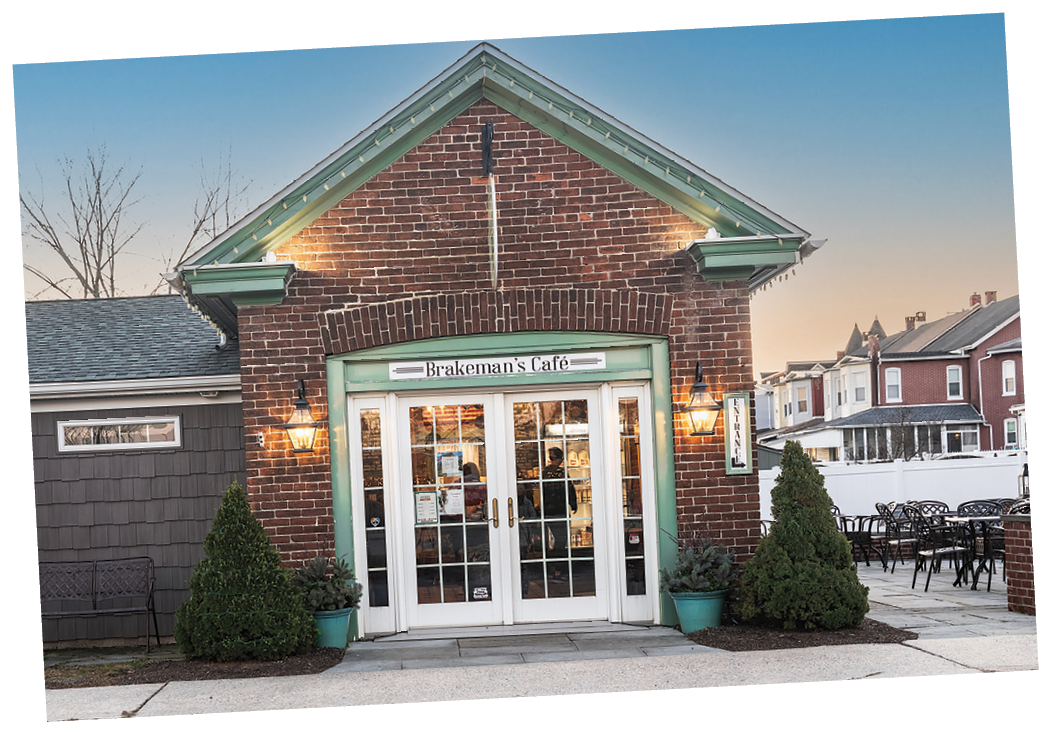 A brick building with a green door and a sign that reads “Hudson's Lodge". AI generated content