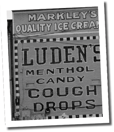 A building with a sign advertising Lunden's Menthol Candy Drops. AI generated content