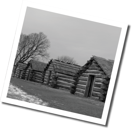 A row of log cabins with snow on the ground in front of them. AI generated content