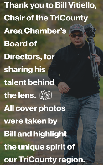 A man wearing a black shirt and hat is holding a camera. AI generated content