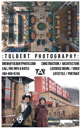 Two people are standing in front of a building, one of them holding a snowboard. AI generated content