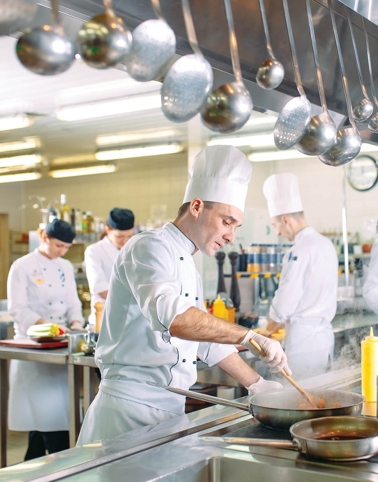Modern kitchen. The chefs prepare meals in the restaurant's kitchen