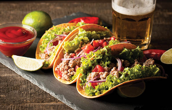 Mexican tacos with ground meat, beef, beans, onions and salsa