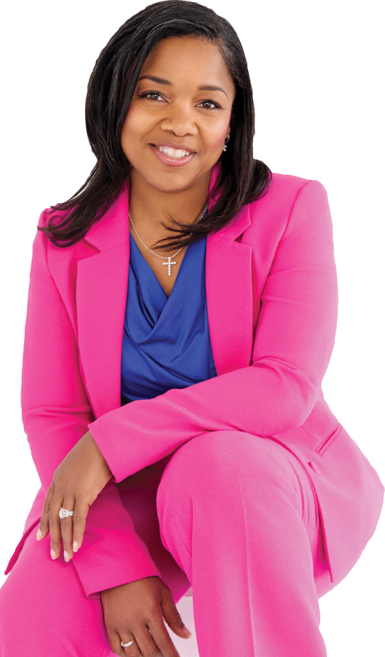 A woman in a pink suit is sitting down. Description generated by AI