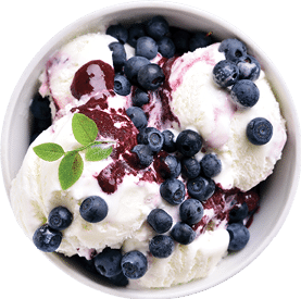 A bowl of blueberry ice cream with a green leaf on top. Description generated by AI