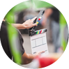 Filming on location. Man holding a clapperboard in front of the camera, the filming process. Scene on location