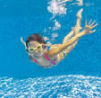 Happy smiling underwater kid in swimming pool