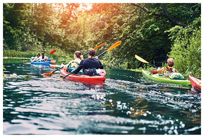 group of young people on kayak outing rafting down the river