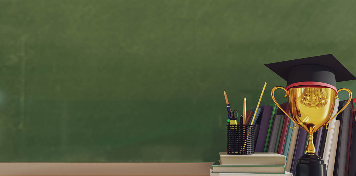 A trophy sits on a desk next to a book. Description generated by AI
