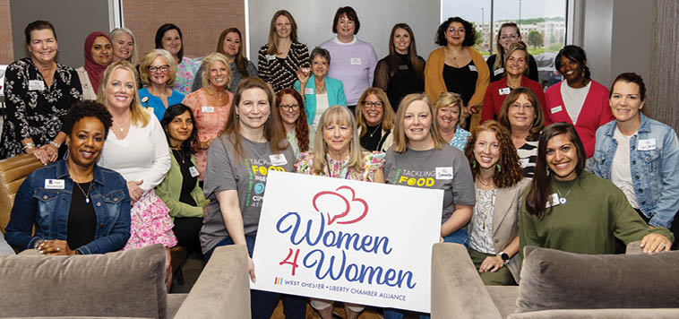 A group of women are posing for a picture. Description generated by AI