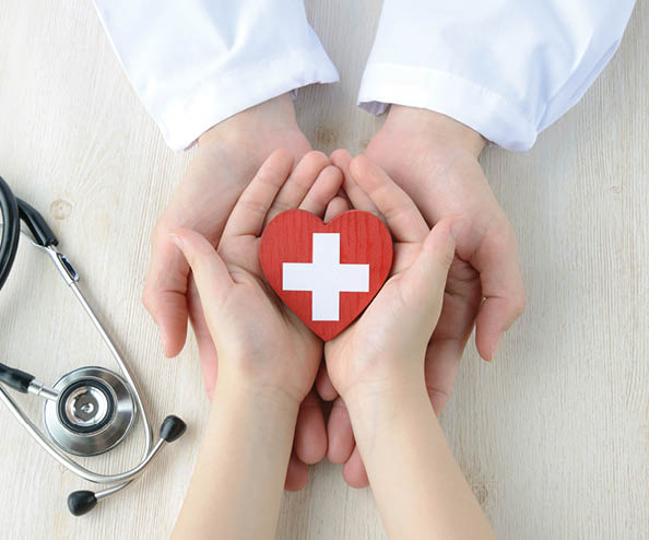 A person holding a heart shaped sticker. Description generated by AI