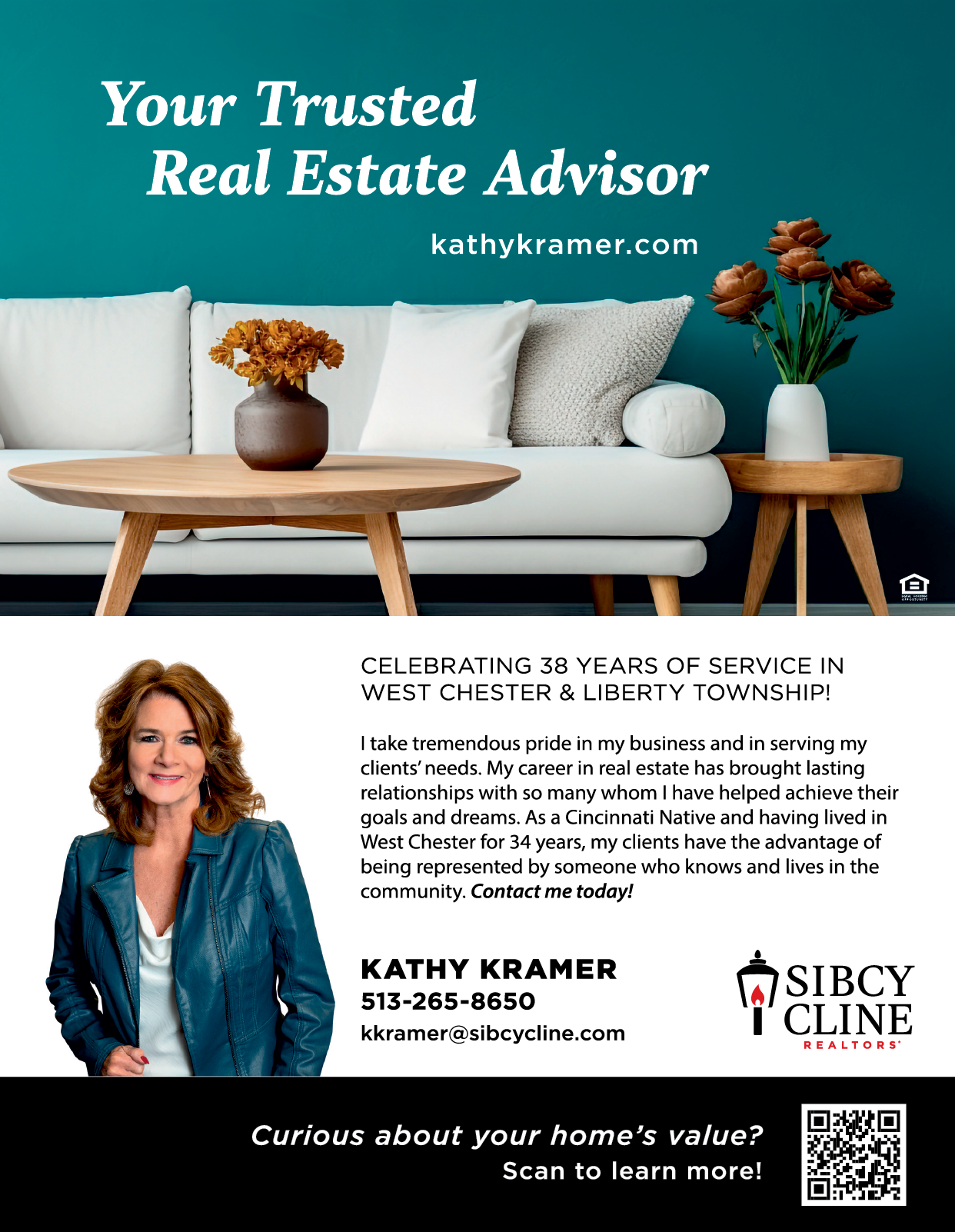 A woman in a blue jacket sits on a couch. Description generated by AI