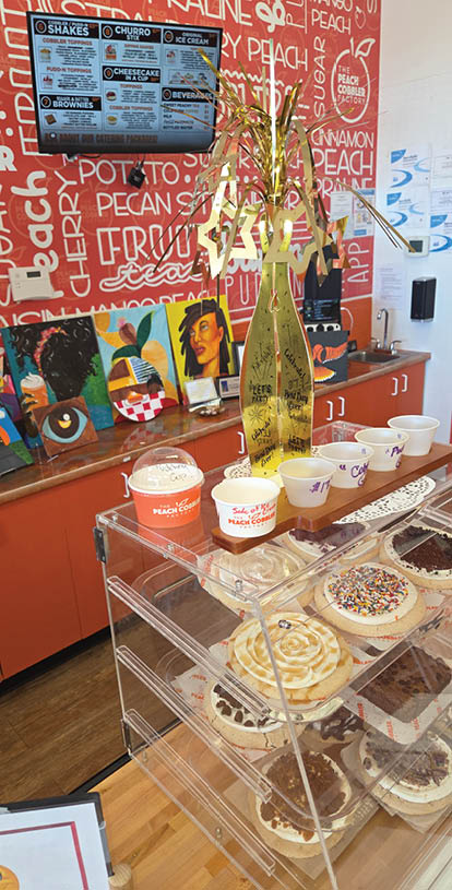 A display of cupcakes in a clear case. Description generated by AI