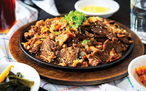 A plate of food with meat and vegetables on a table. AI generated content