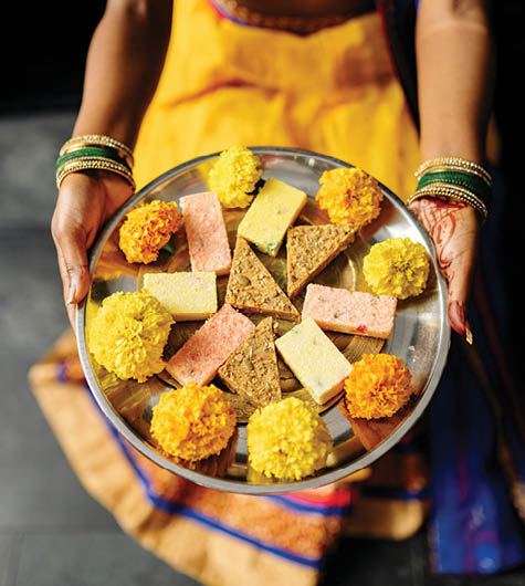 A woman is holding a plate with various food items on it. AI generated content