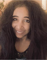A woman with long hair and a smile on her face. AI generated content
