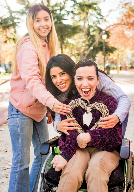 Latin women friends group fight for social inclusion for disability friend on wheelchair with cerebral palsy. Latin Female international womens day togetherness outdoor