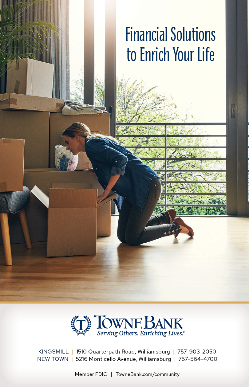 A woman kneeling on a wooden floor in front of boxes. Description generated by AI