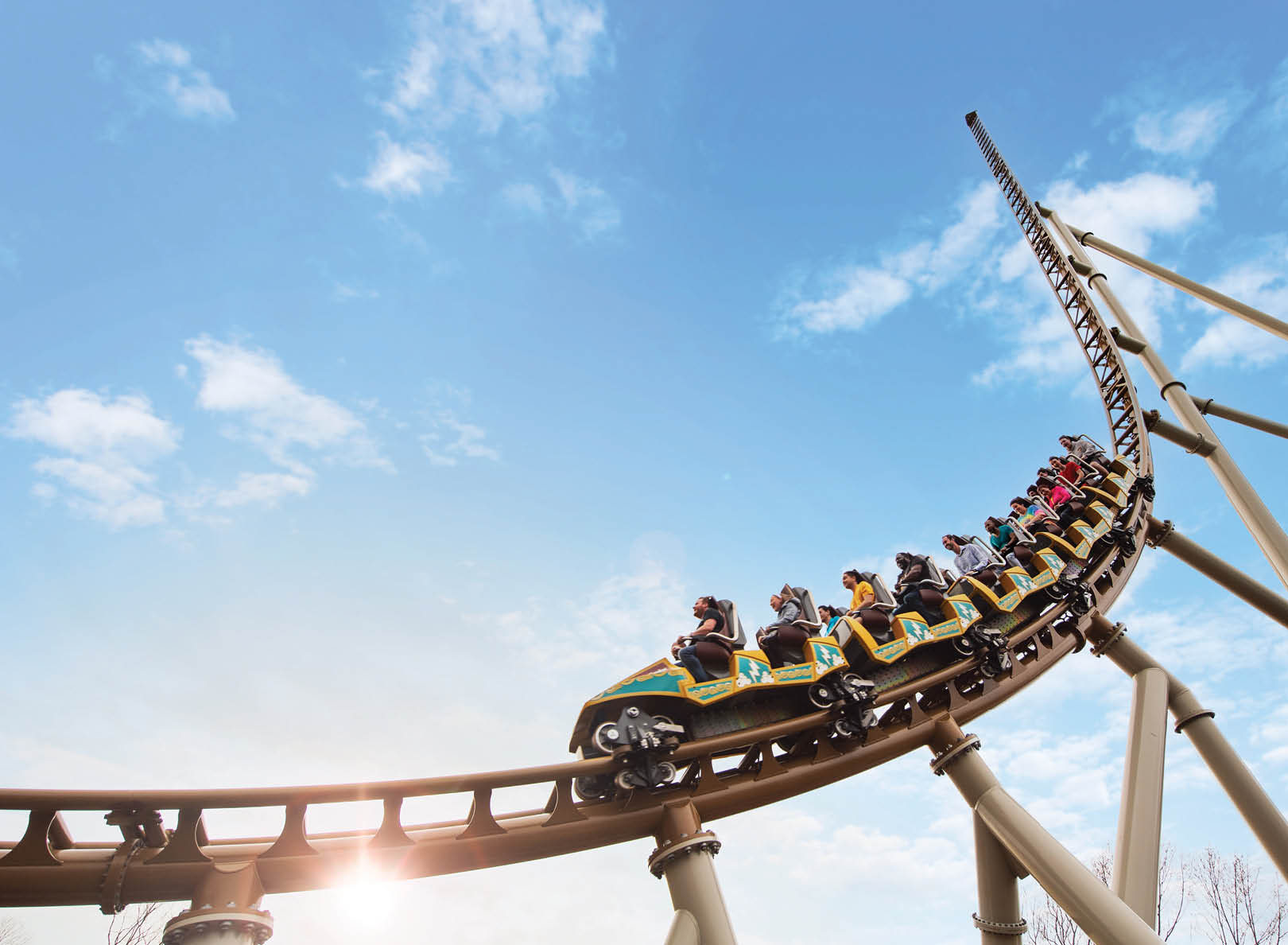 A roller coaster with people riding it. Description generated by AI