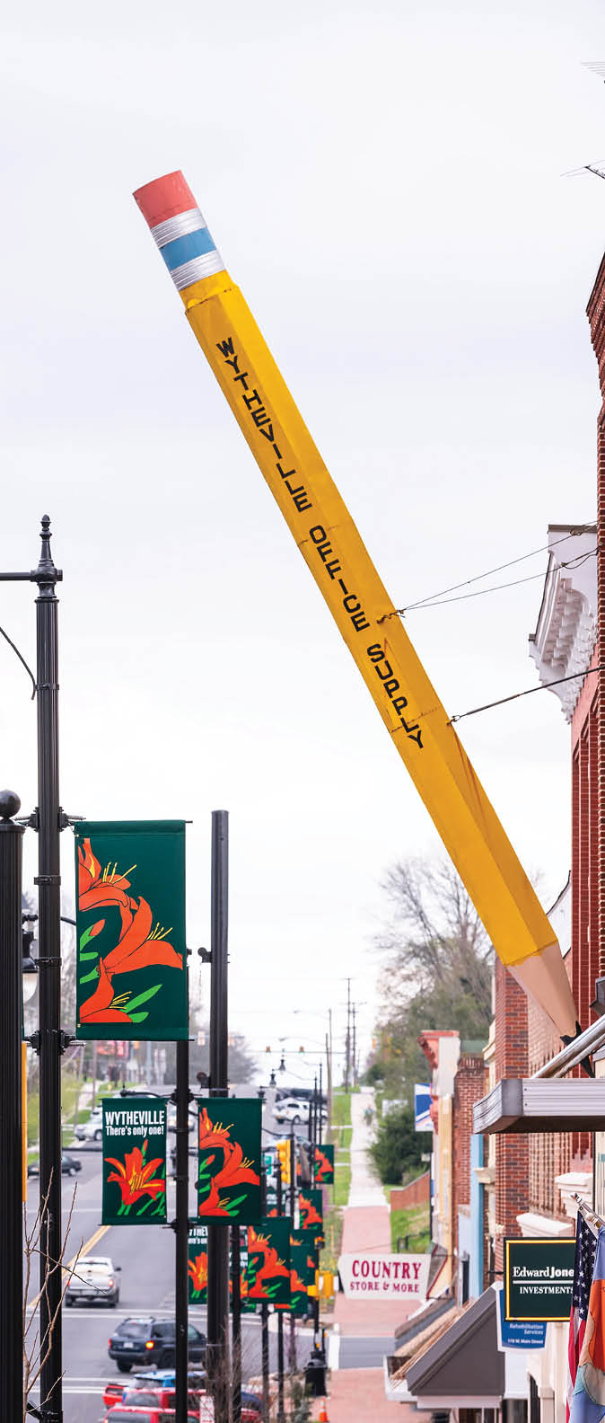 Wytheville, USA - April 19, 2018: Small town village sign for office supply in southern Virginia with largest big pencil exterior on sidewalk