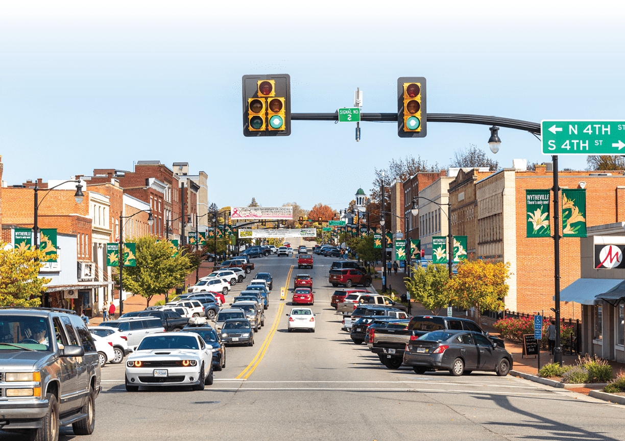 Wytheville, VA, USA-15 October 2022: Wide-angle view of Main Street at 4th showing buildings and street busy with traffic and people. Sunny, autumn day.