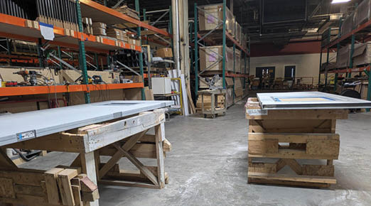A large workshop with two tables and a shelf. AI generated content