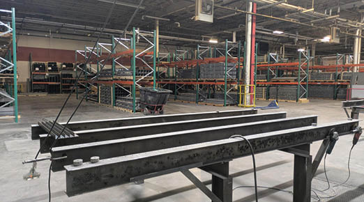 A large metal beam is sitting in a warehouse. AI generated content