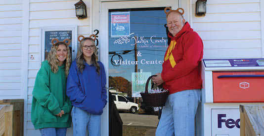 Three people wearing costumes pose for a picture in front of a building. AI generated content