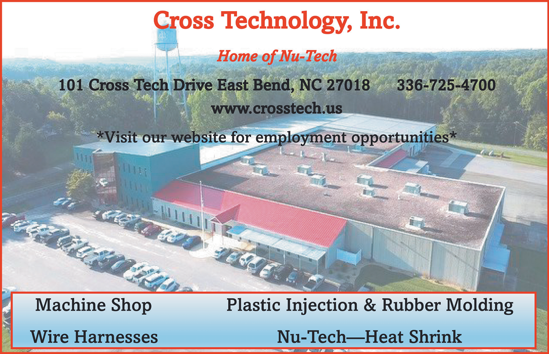 A large building with a red roof and a green trim. The building is a machine shop that specializes in plastic injection and rubber molding. The building also has a wire harness division and a n-tech division. AI generated content