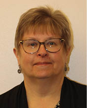 A woman with short hair and glasses is smiling for the camera. AI generated content