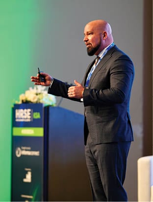 A man in a suit and tie is giving a presentation. AI generated content