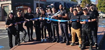 A group of people are standing in front of a sushi restaurant, posing for a picture. AI generated content