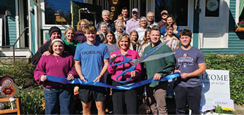 A group of people are standing in front of a building, holding a blue ribbon. AI generated content