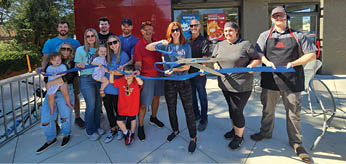 A group of people are standing in front of a DQ and Grill & Chill restaurant. AI generated content